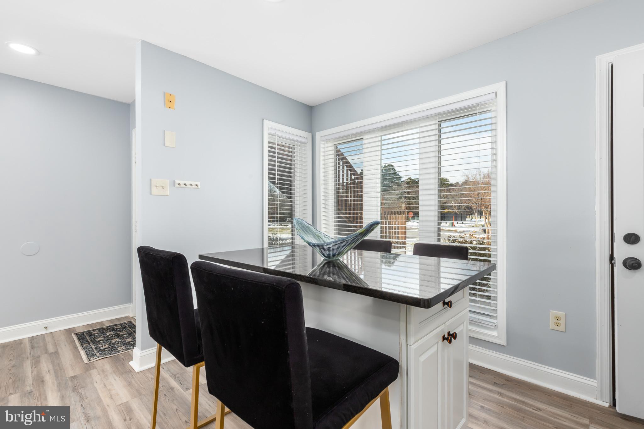11602 Masters Lane, Unit 120 Berlin, MD 21811 - Photo 5 of 29 a dining room with furniture and wooden floor