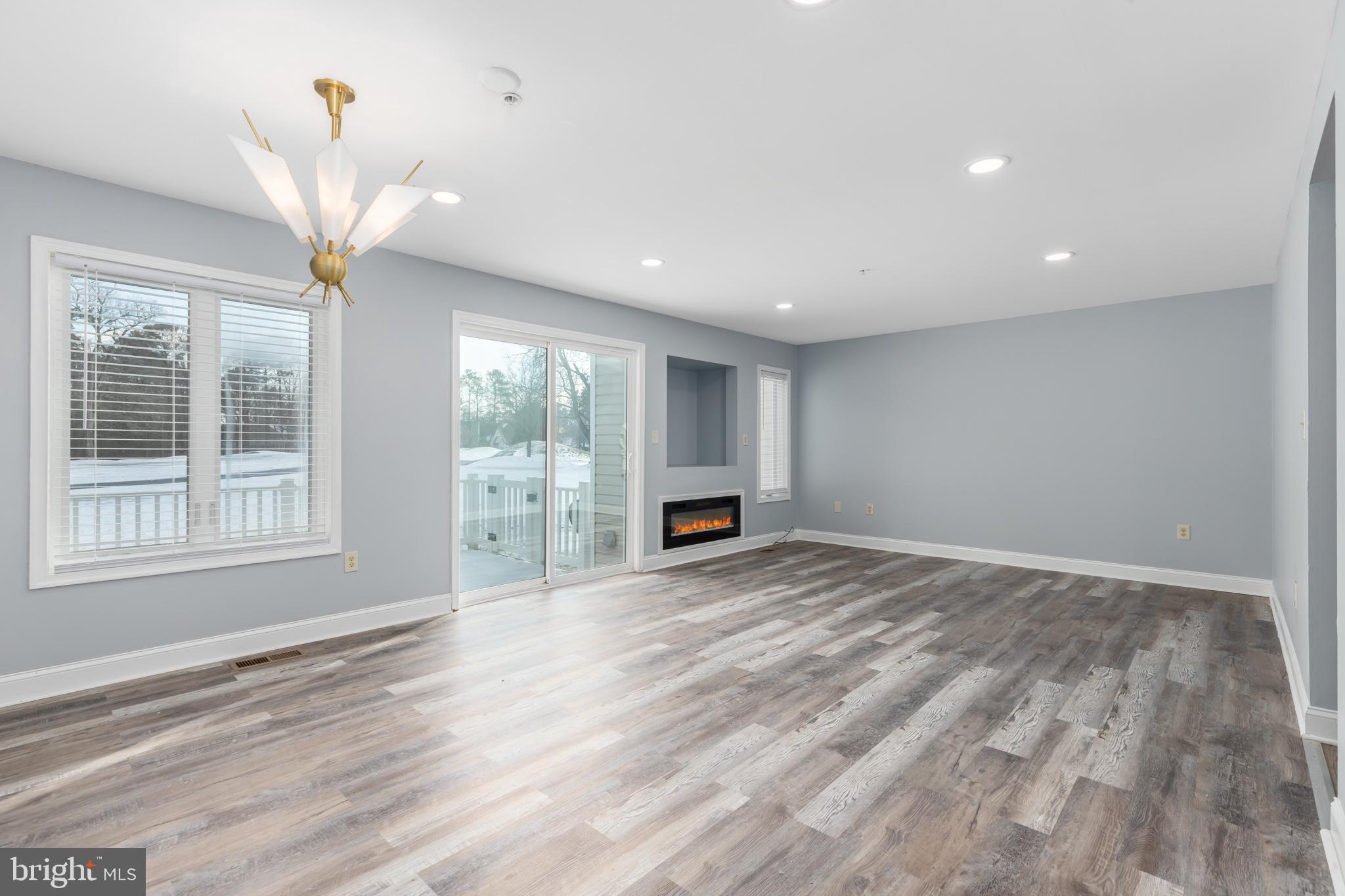 11602 Masters Lane, Unit 120 Berlin, MD 21811 - Photo 7 of 29 a view of empty room with wooden floor and fan