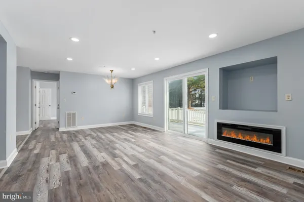 a view of empty room with a fireplace
