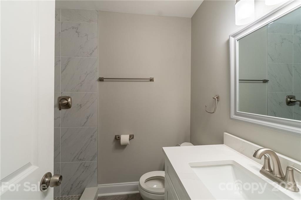 721 Rome Court Charlotte, NC 28209 - Photo 12 of 21 a bathroom with a sink a toilet and shower