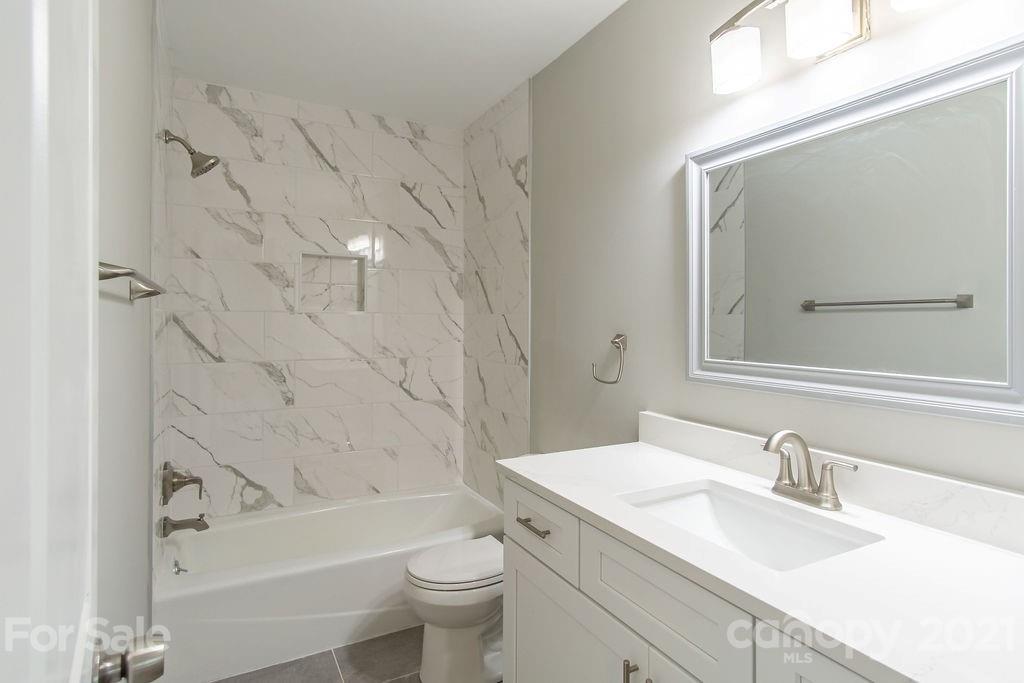 721 Rome Court Charlotte, NC 28209 - Photo 16 of 21 a bathroom with a granite countertop sink toilet and shower