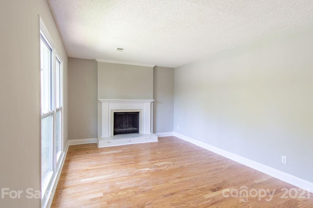 721 Rome Court Charlotte, NC 28209 - Photo 5 of 21 a view of an empty room with a window and a fireplace