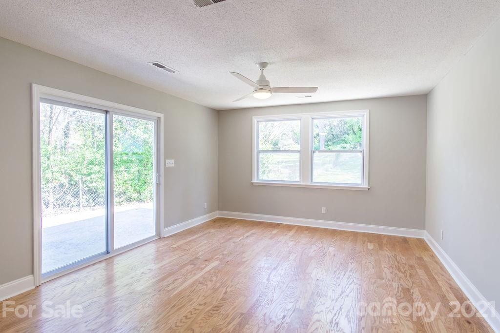 721 Rome Court Charlotte, NC 28209 - Photo 9 of 21 a view of an empty room with wooden floor and a window