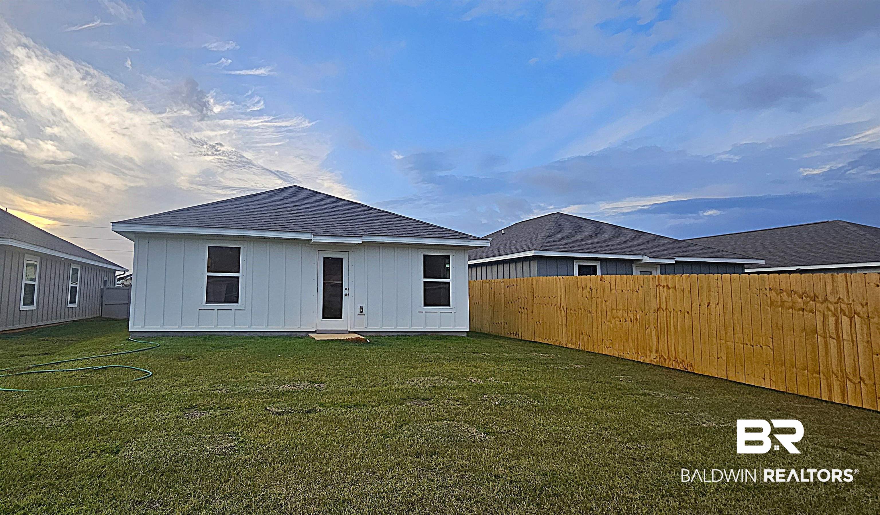 1148 Sweet Laurel Street Foley, AL 36535 - Photo 4 of 18 Back house at dusk featuring a yard