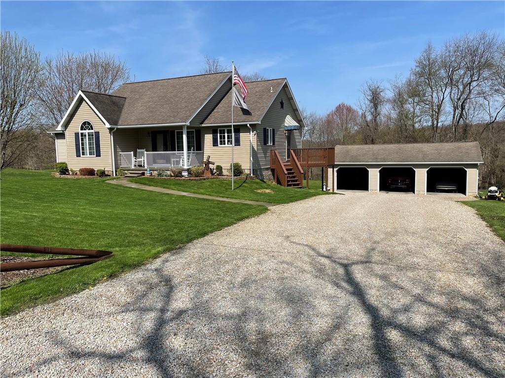 222 Snuff Ridge Road New Salem, PA 15468 - Photo 1 of 25 a view of a white house with a yard and plants
