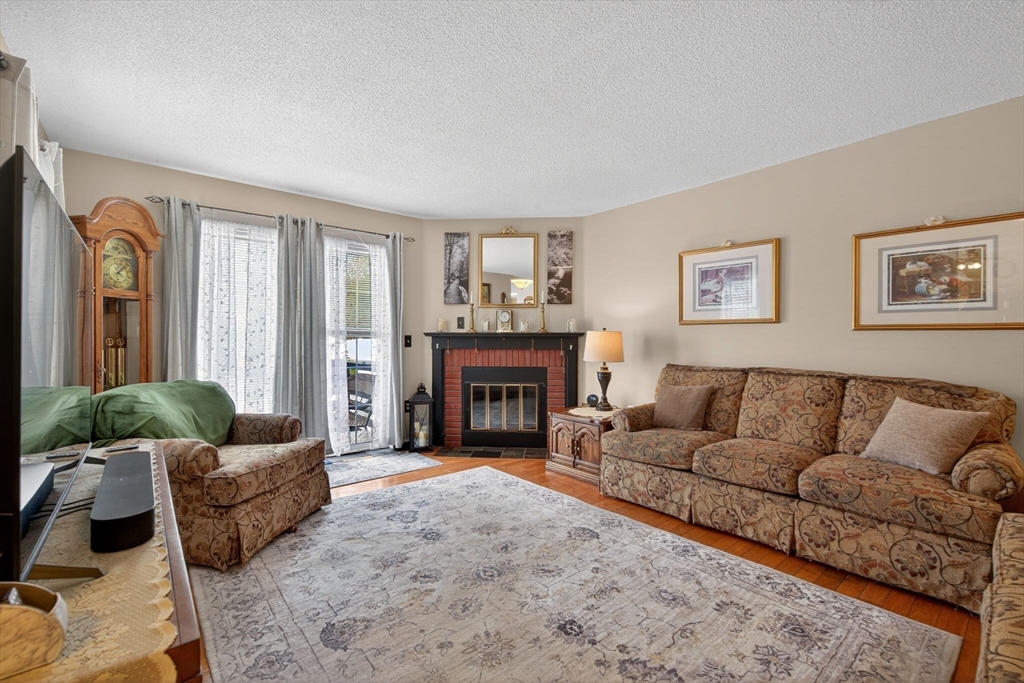 104 Johnson Road, Unit 1103 Chicopee, MA 01022 - Photo 11 of 42 a living room with furniture and a fireplace