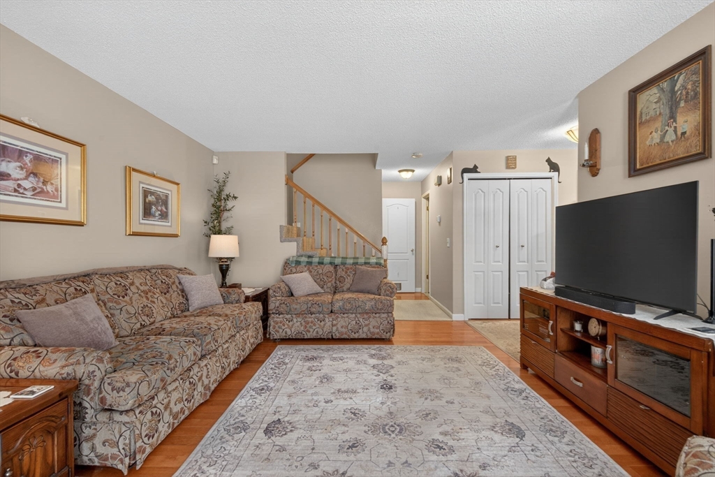 104 Johnson Road, Unit 1103 Chicopee, MA 01022 - Photo 13 of 42 a living room with furniture and a flat screen tv