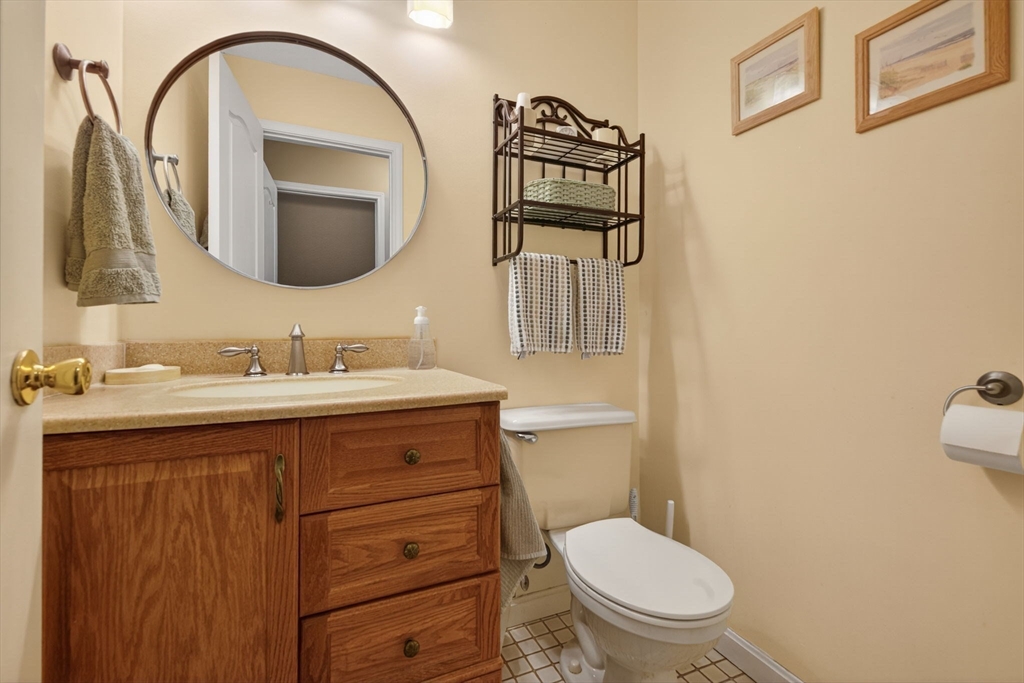 104 Johnson Road, Unit 1103 Chicopee, MA 01022 - Photo 14 of 42 a bathroom with a toilet a sink and mirror