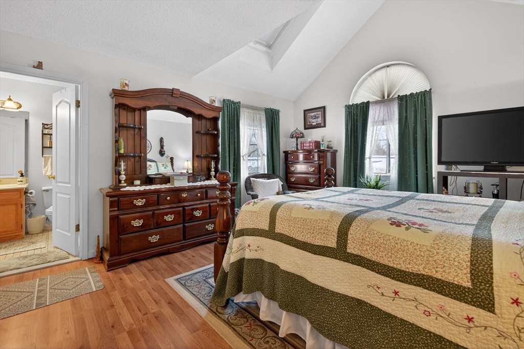 104 Johnson Road, Unit 1103 Chicopee, MA 01022 - Photo 19 of 42 a spacious bedroom with a bed and a flat screen tv
