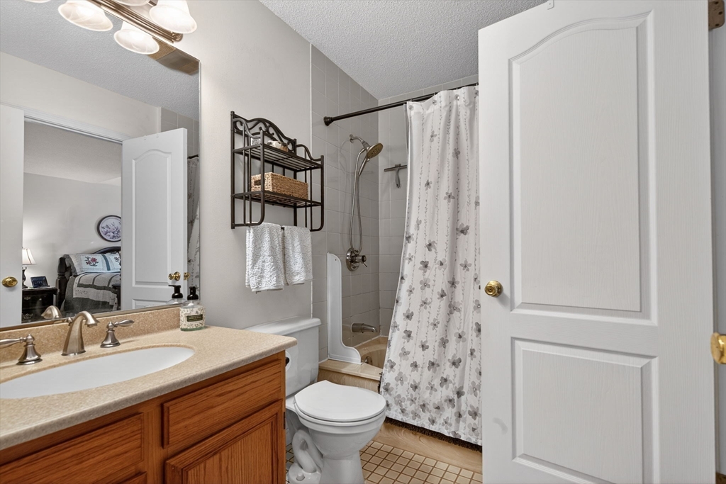 104 Johnson Road, Unit 1103 Chicopee, MA 01022 - Photo 20 of 42 a bathroom with a granite countertop sink toilet and shower