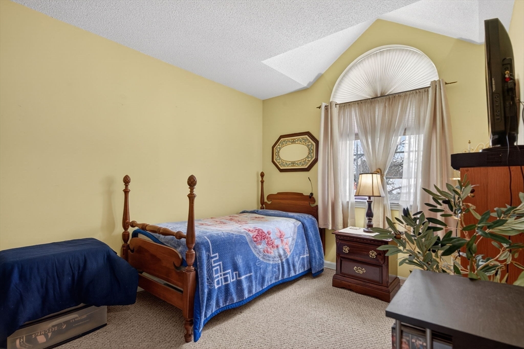 104 Johnson Road, Unit 1103 Chicopee, MA 01022 - Photo 22 of 42 a bedroom with bed and a flat tv screen on dresser