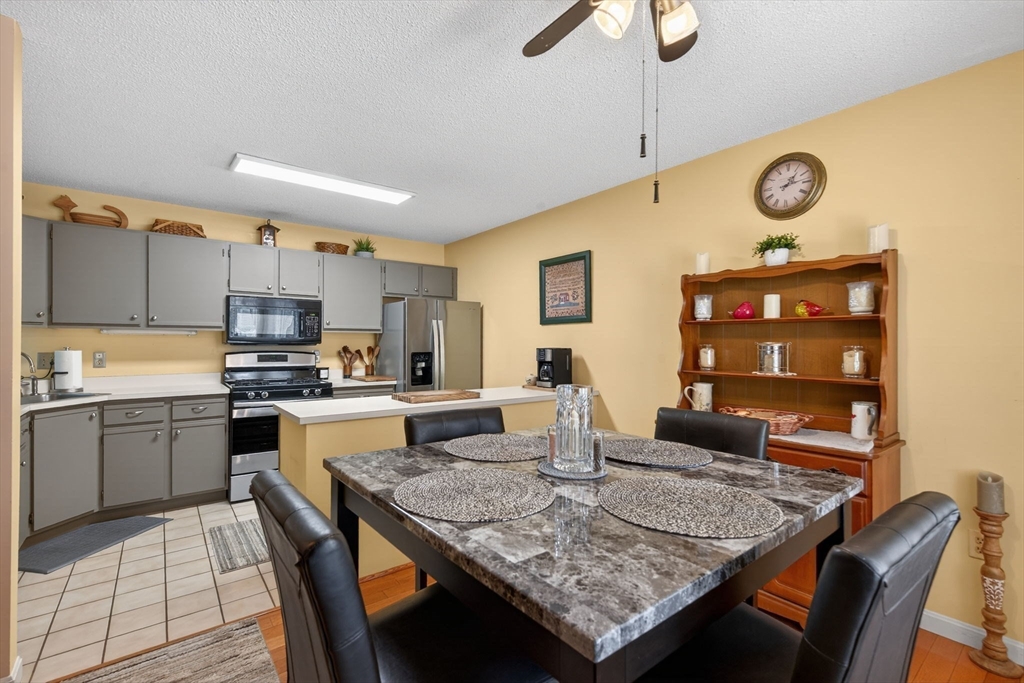 104 Johnson Road, Unit 1103 Chicopee, MA 01022 - Photo 6 of 42 a kitchen with granite countertop kitchen island stainless steel appliances a stove refrigerator sink and cabinets
