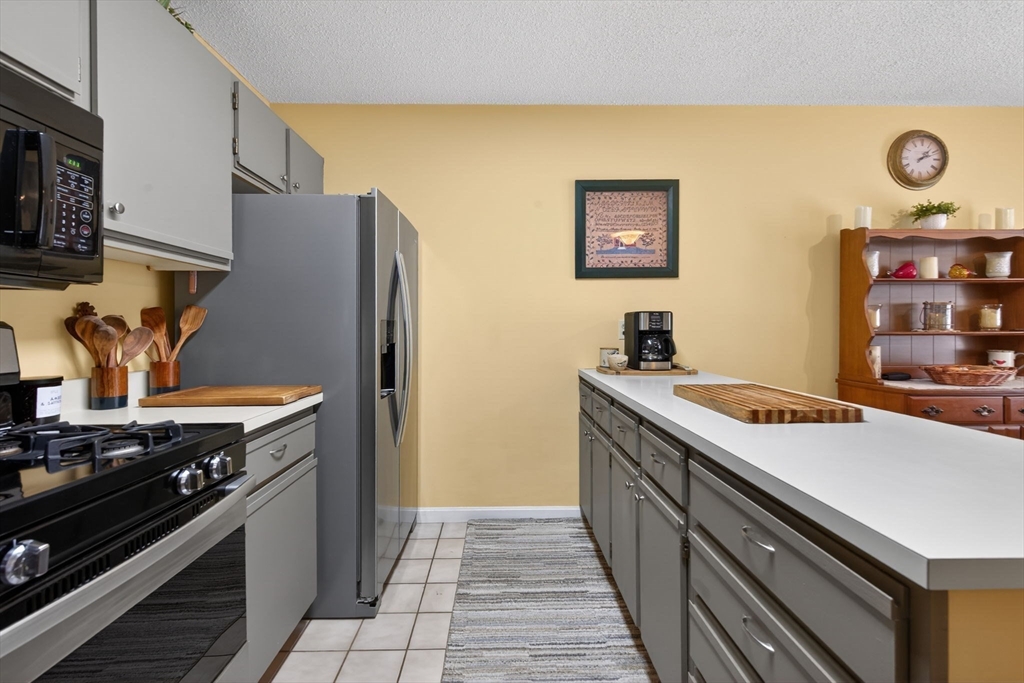 104 Johnson Road, Unit 1103 Chicopee, MA 01022 - Photo 8 of 42 a kitchen with stainless steel appliances granite countertop a stove and a refrigerator