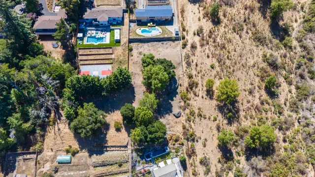 an aerial view of a house with a yard and garden