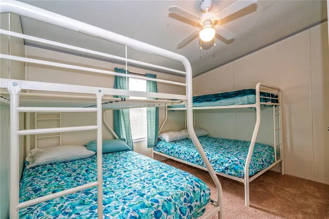 a room with wooden floor and a rug