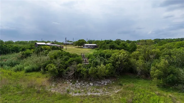 a view of a swimming pool with lawn chairs and couches