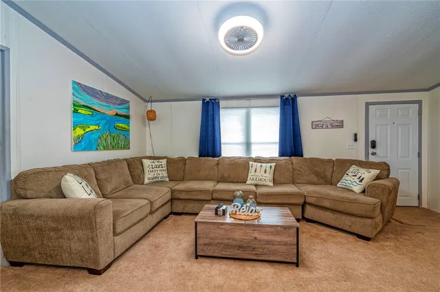 a living room with couches and painting on the wall