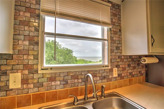 a bathroom with a sink and a large window