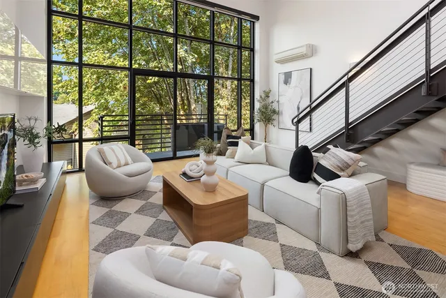 a living room with furniture and a floor to ceiling window