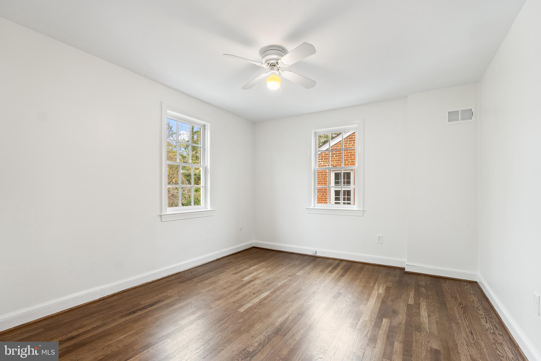4521 Clark Place Northwest Washington, DC 20007 - Photo 16 of 27 a view of an empty room with wooden floor and a window