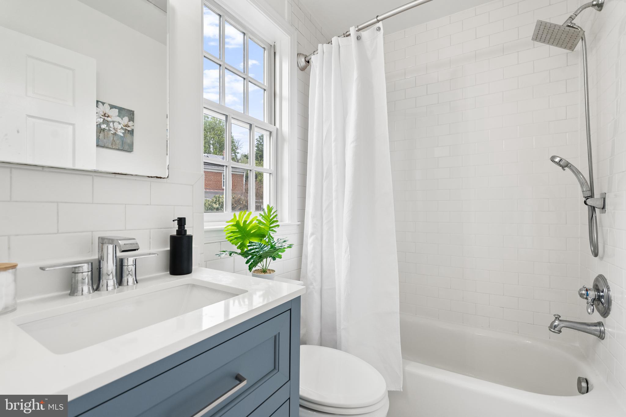 4521 Clark Place Northwest Washington, DC 20007 - Photo 17 of 27 a bathroom with a sink a toilet and shower