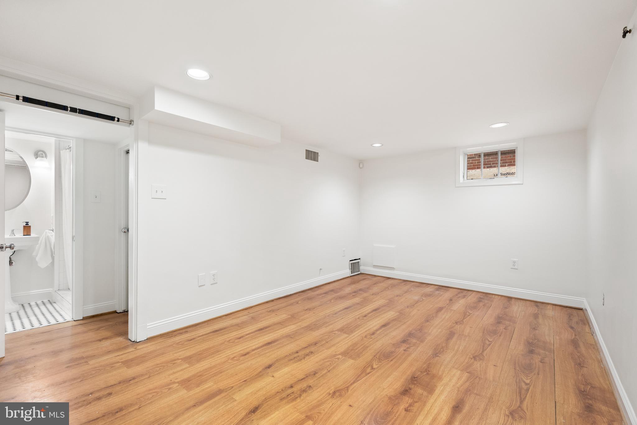 4521 Clark Place Northwest Washington, DC 20007 - Photo 19 of 27 a view of empty room with wooden floor and fan