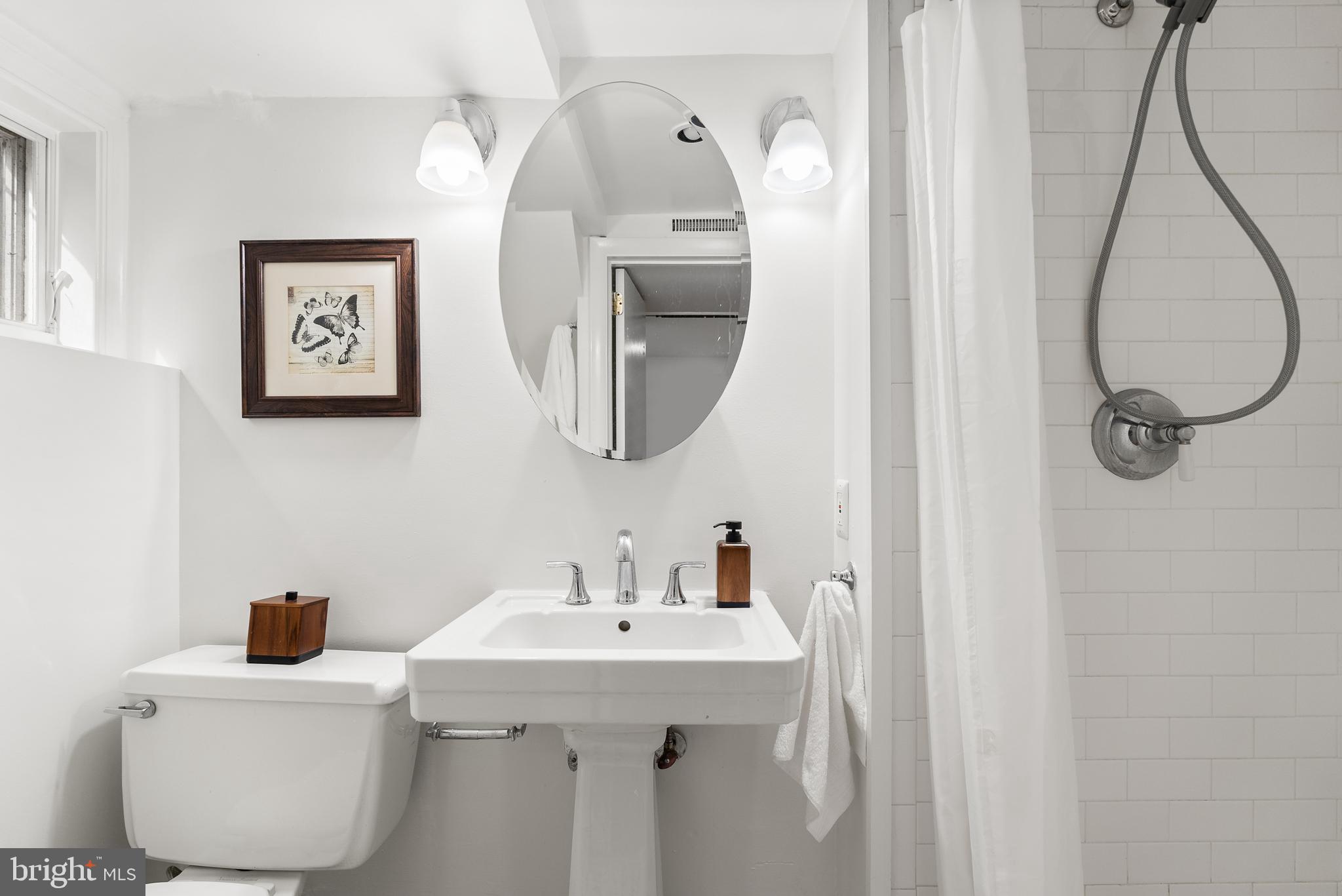 4521 Clark Place Northwest Washington, DC 20007 - Photo 20 of 27 a bathroom with a sink and mirror