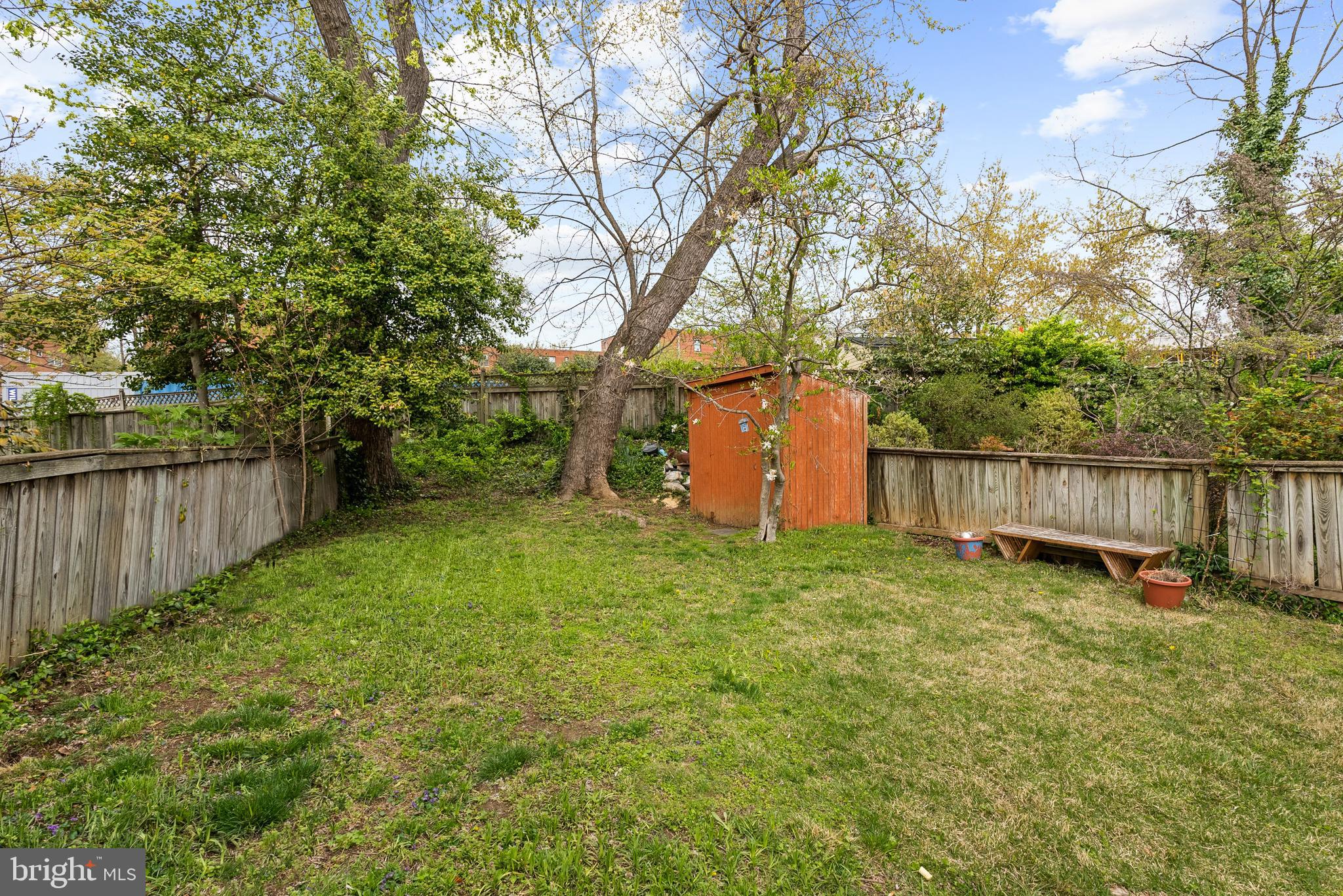 4521 Clark Place Northwest Washington, DC 20007 - Photo 23 of 27 a view of a backyard with large trees and wooden fence