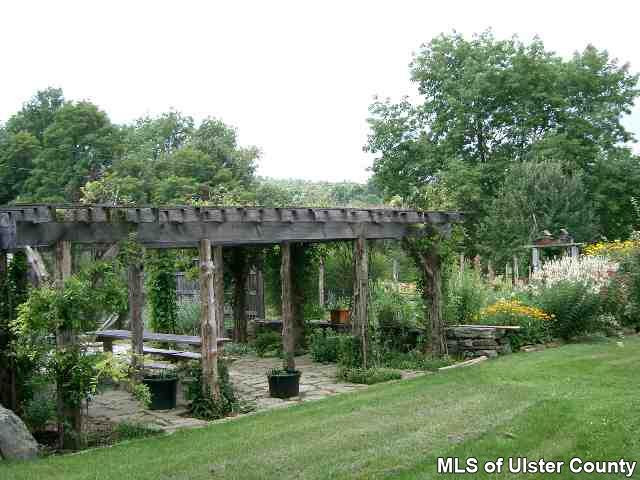 660 Vly Road Stone Ridge, NY 12484 - Photo 3 of 5 a view of a house with backyard sitting area and garden