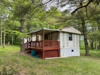 Rear view of property with a yard