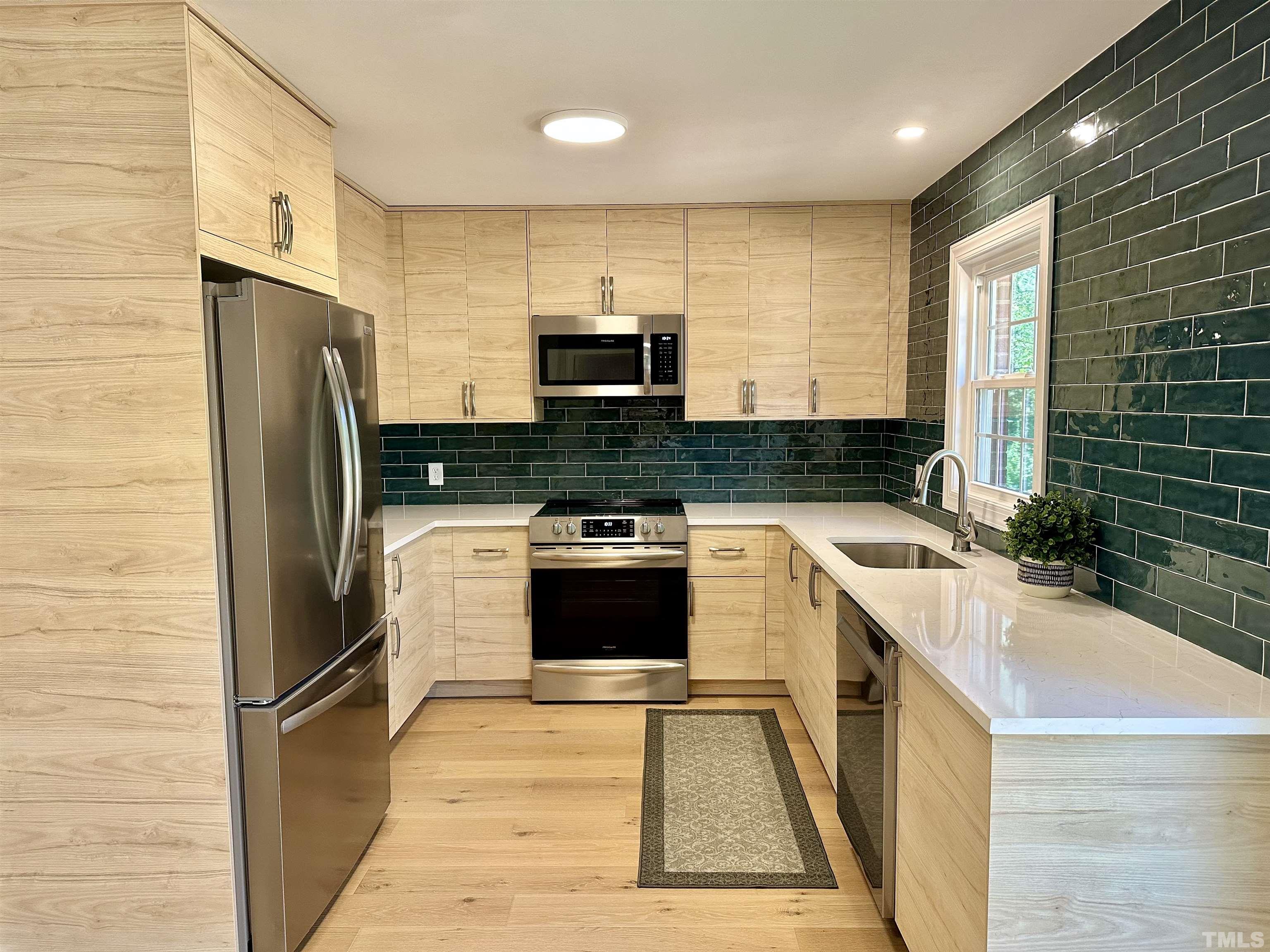 8904 Ransdell Road Raleigh, NC 27603 - Photo 1 of 23 a kitchen with a refrigerator a sink and a stove