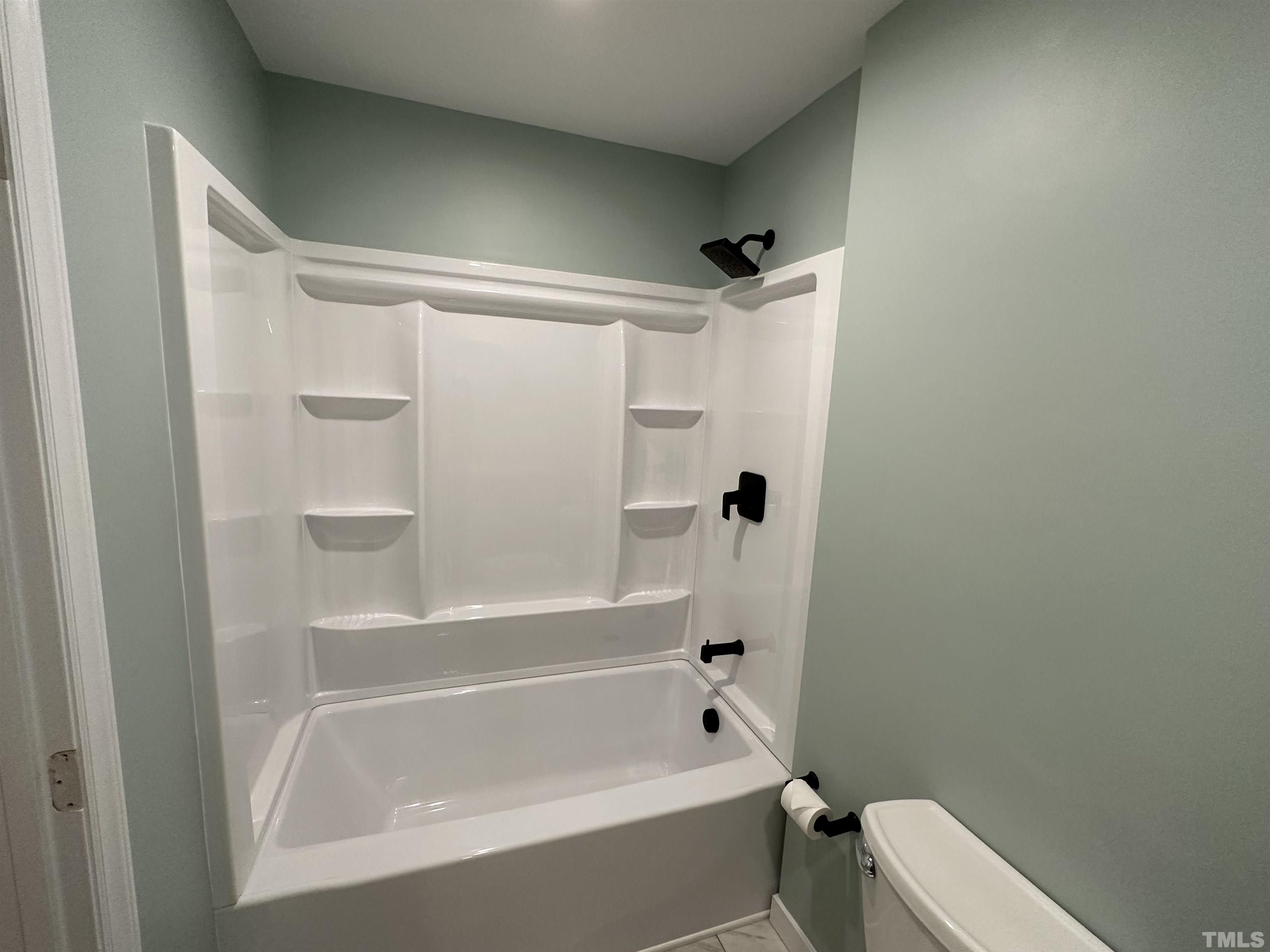 8904 Ransdell Road Raleigh, NC 27603 - Photo 15 of 23 a bathroom with a bathtub and a toilet