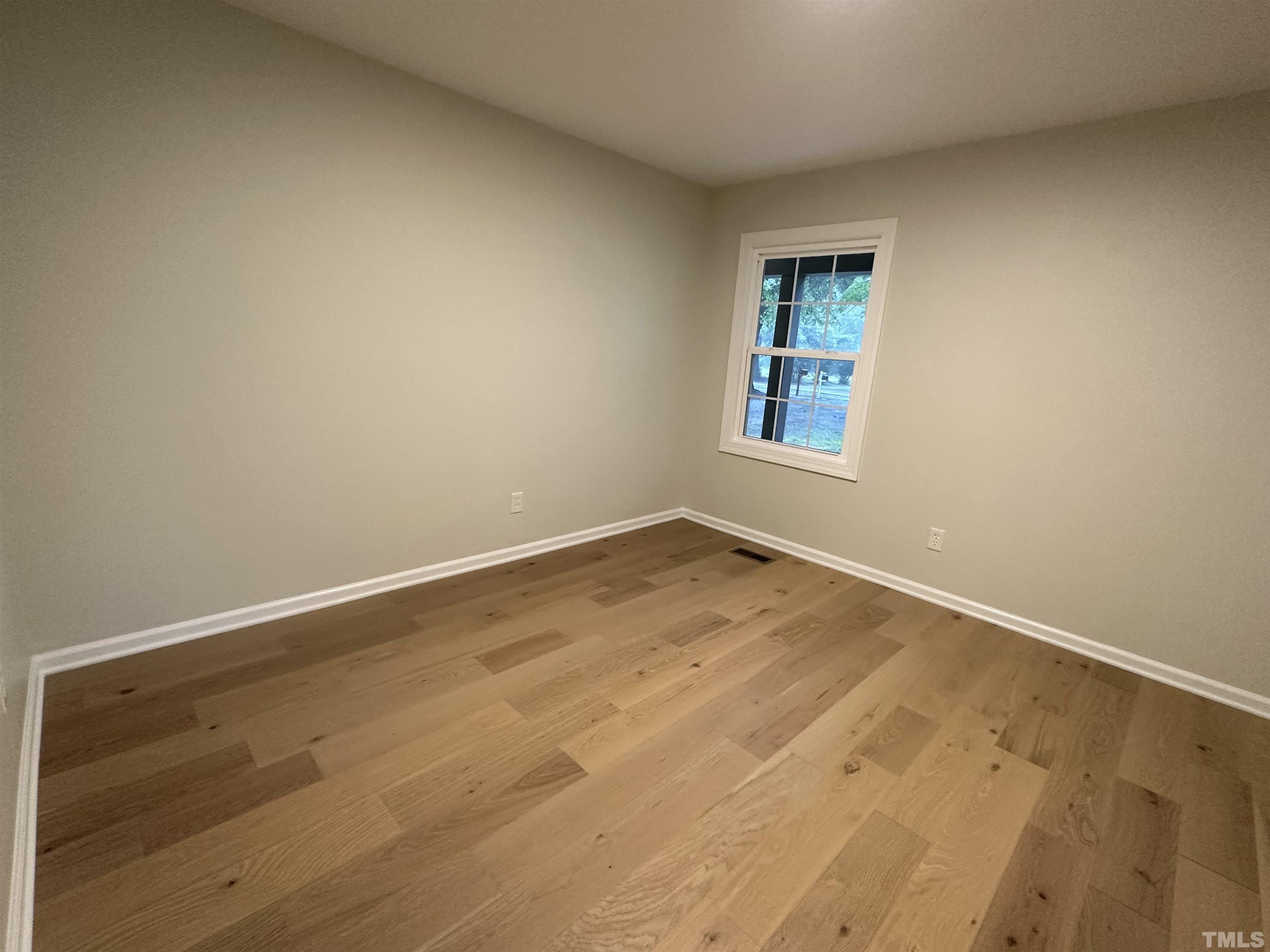 8904 Ransdell Road Raleigh, NC 27603 - Photo 17 of 23 an empty room with wooden floor and windows