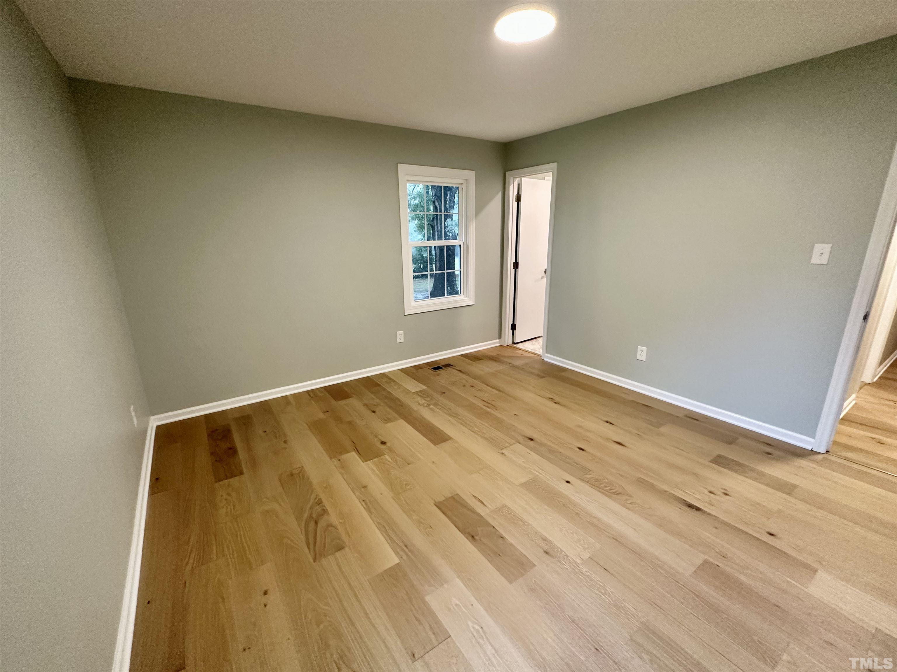 8904 Ransdell Road Raleigh, NC 27603 - Photo 18 of 23 a view of room with wooden floor