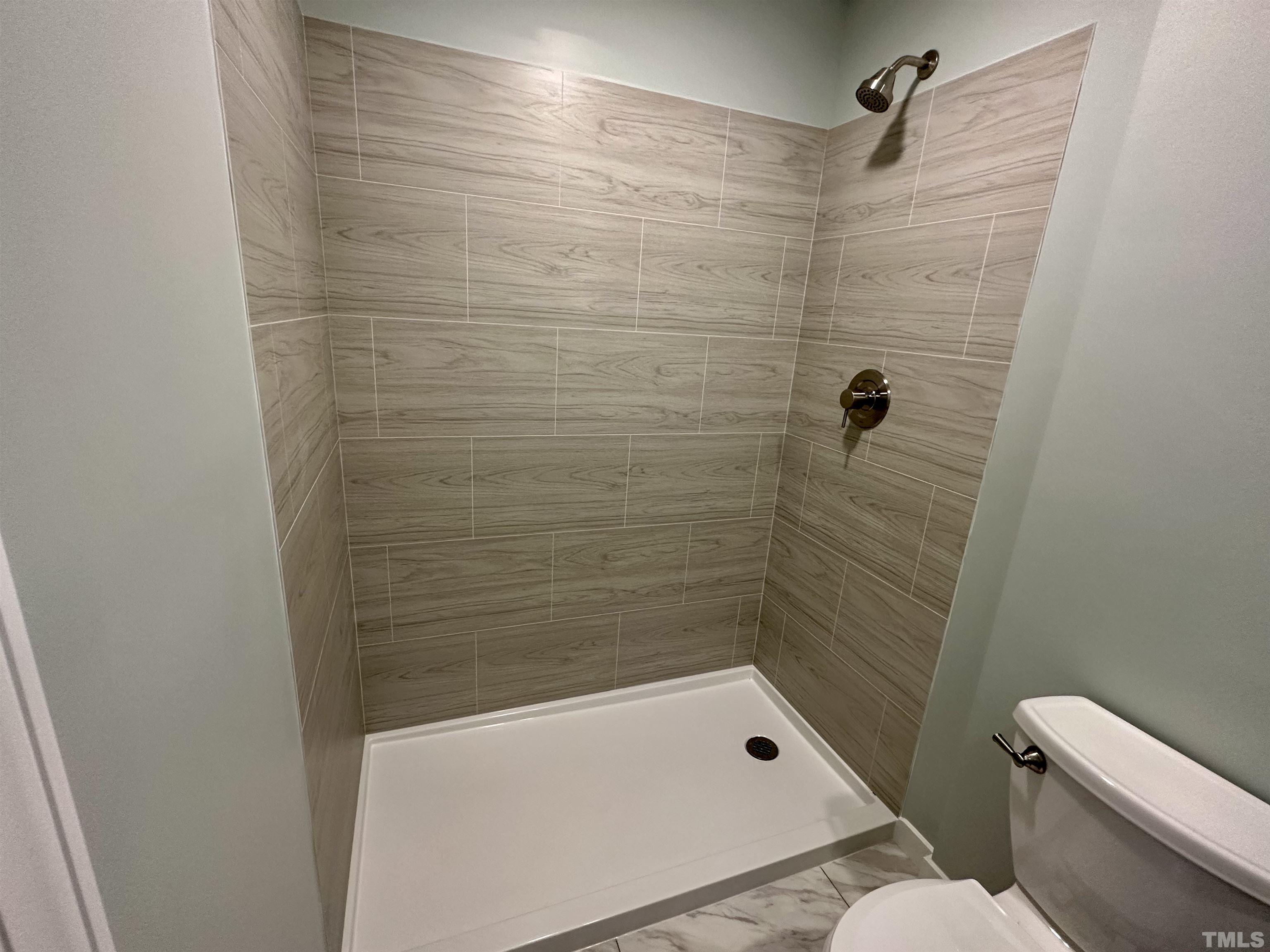 8904 Ransdell Road Raleigh, NC 27603 - Photo 21 of 23 a bathroom with a shower and a toilet