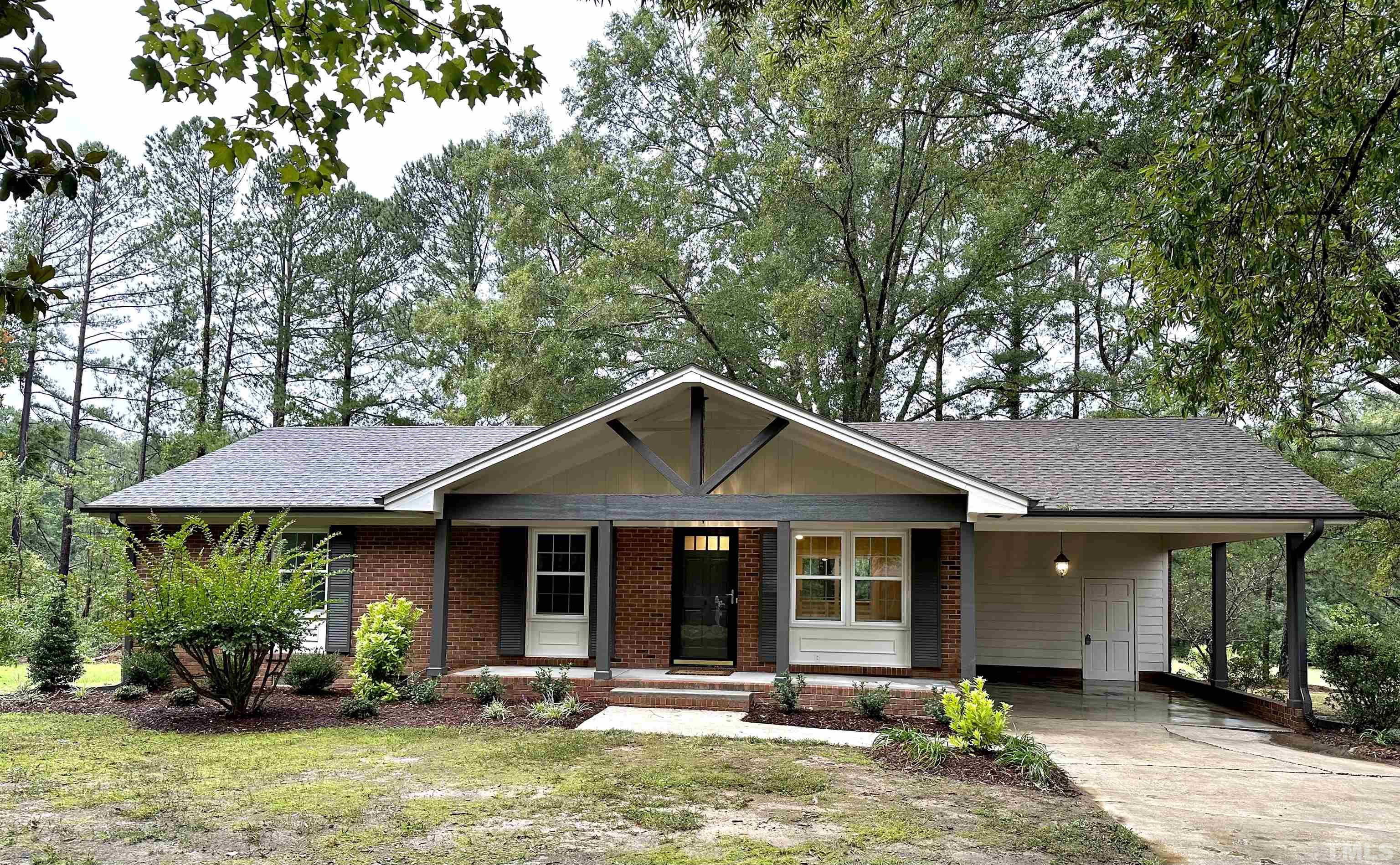 8904 Ransdell Road Raleigh, NC 27603 - Photo 3 of 23 a front view of a house with a garden and porch