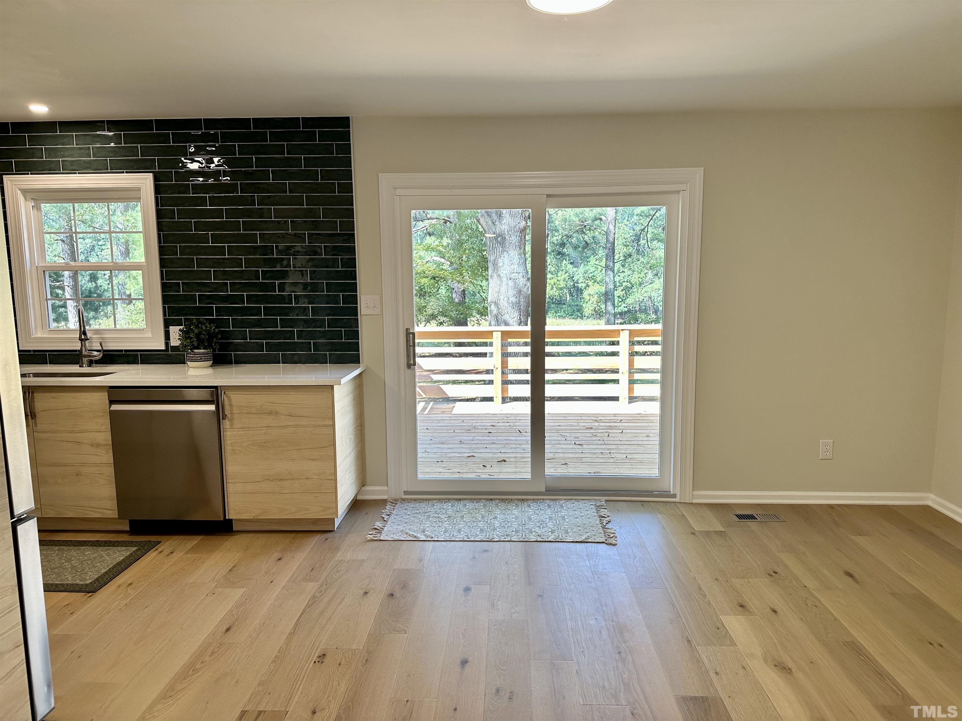 8904 Ransdell Road Raleigh, NC 27603 - Photo 7 of 23 an empty room with wooden floor and windows