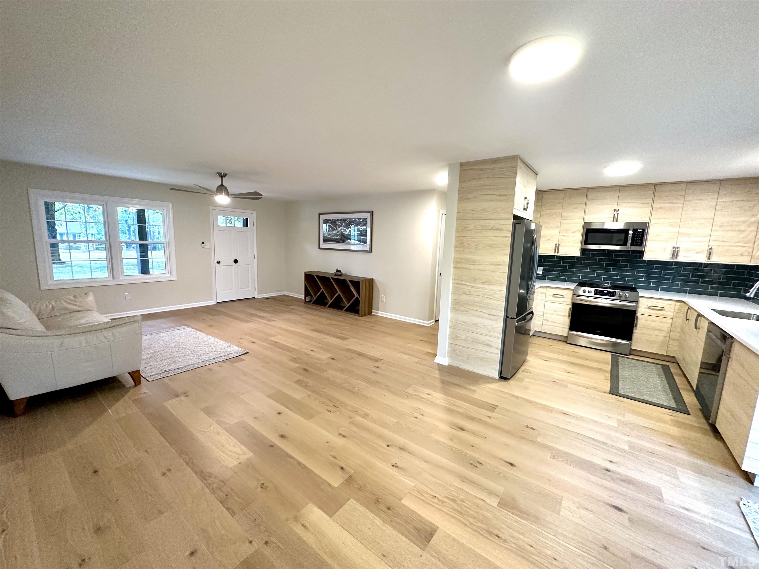 8904 Ransdell Road Raleigh, NC 27603 - Photo 9 of 23 a view of a living room kitchen and a window