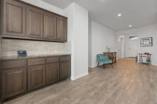 a large kitchen with a table and chairs