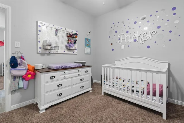 a bedroom with furniture and baby crib