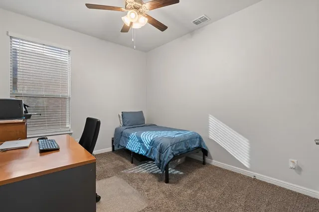 a bedroom with a bed and a desk