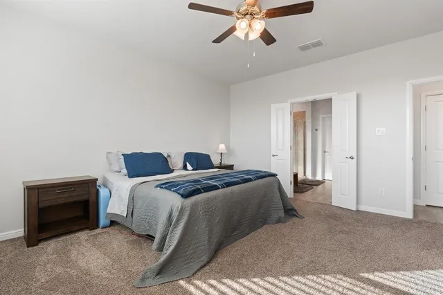 a bedroom with a bed and a chandelier