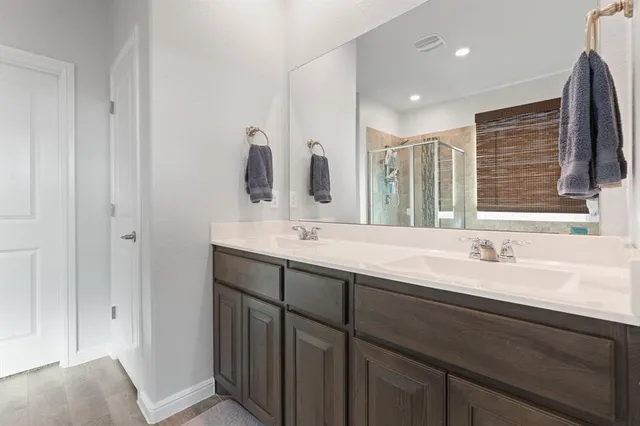 a bathroom with a double vanity sink and a mirror