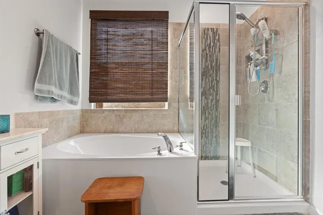 a bathroom with a tub and a shower