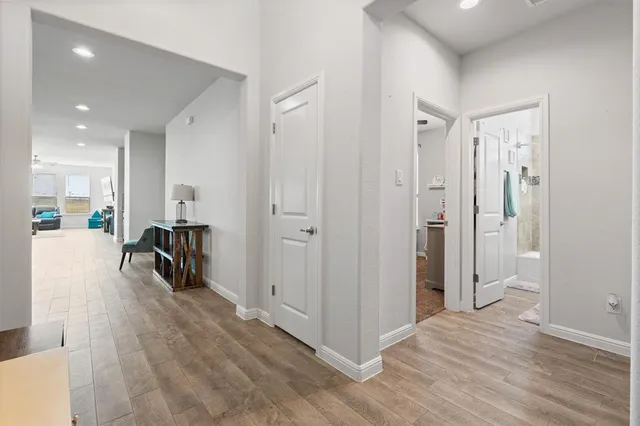 a view of a hallway with wooden floor
