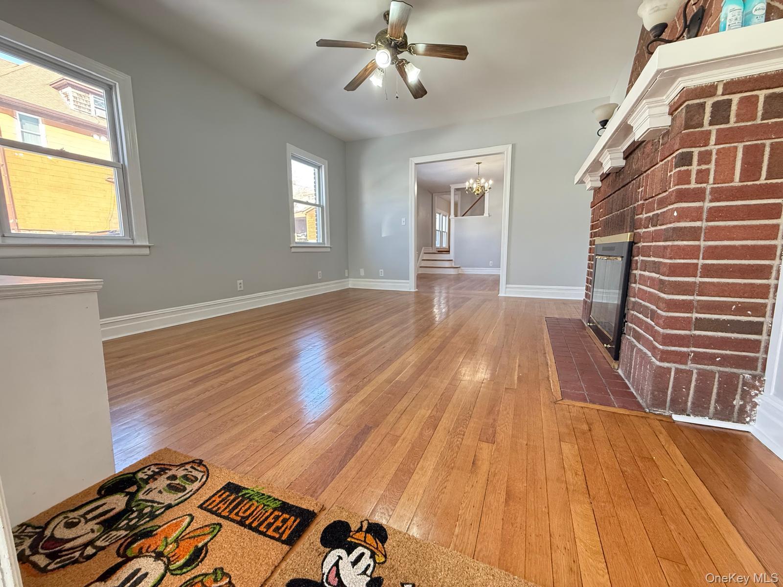 7 Flower Street New Rochelle, NY 10801 - Photo 3 of 13 wooden floor in an empty room with a window