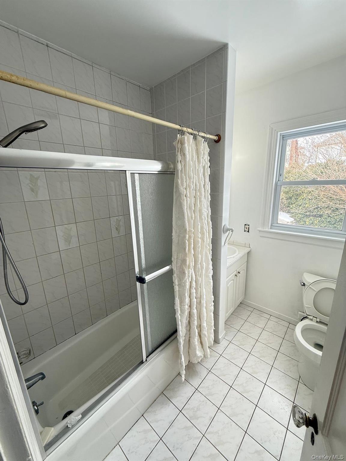 7 Flower Street New Rochelle, NY 10801 - Photo 9 of 13 a bathroom with a shower and a toilet