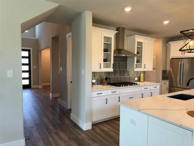 a kitchen with a dining table chairs and refrigerator