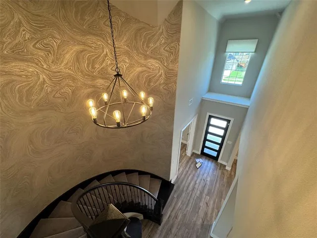 a kitchen with kitchen island granite countertop a sink cabinets and wooden floor