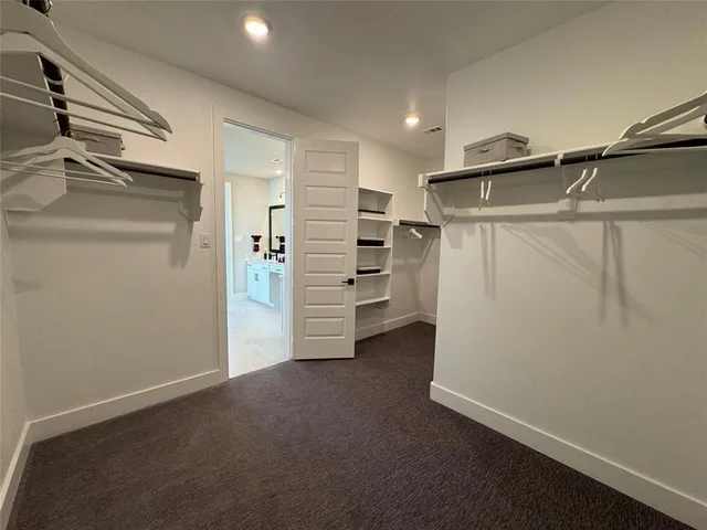 a large white kitchen with a refrigerator a stove a sink and a large window
